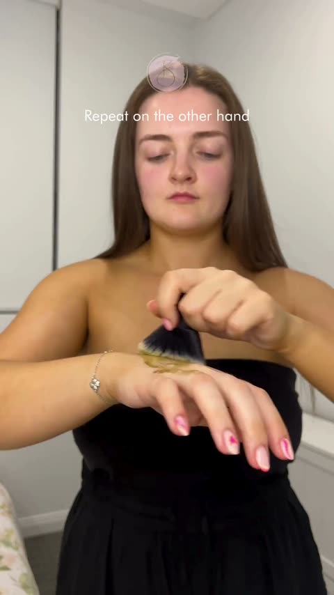 Creator applying self-tan with a brush